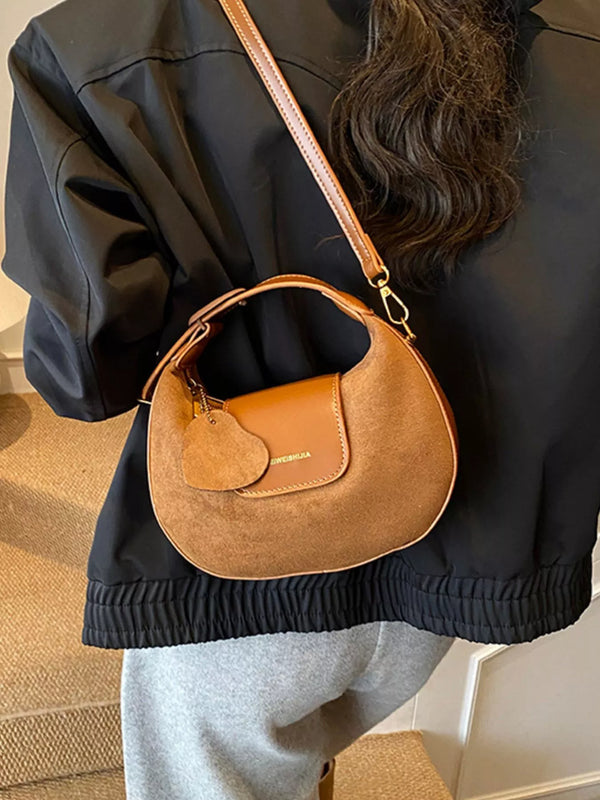 Caramel suede crescent hobo bag with front flap pocket and top handle